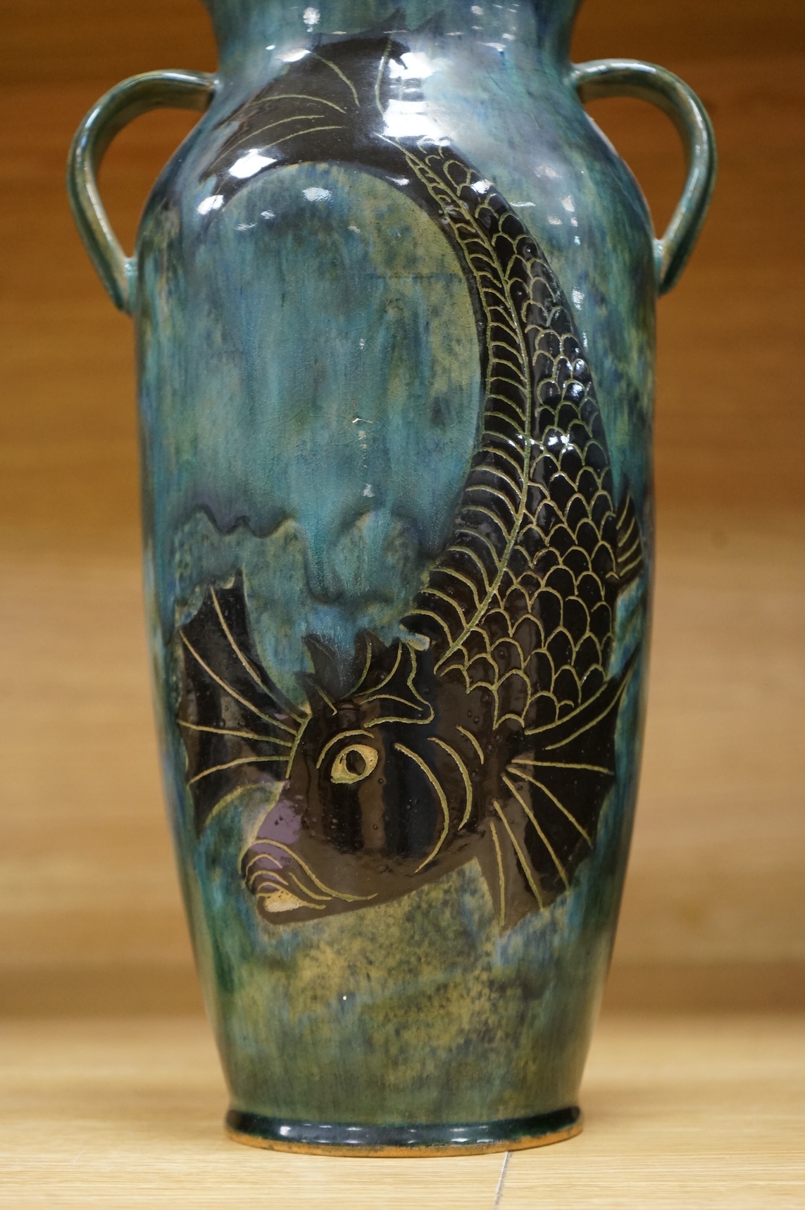 Jane Bridger, a fish designed, green glazed studio pottery two handled vase. 34cm high.
